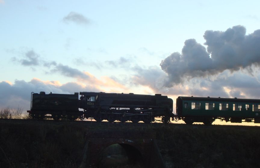 B.R. Standard class '9F' 2-10-0, No. 92212, seen here climbing towards Ropley with a late afternoon service from Alresford to Alton. (27th December 2009)