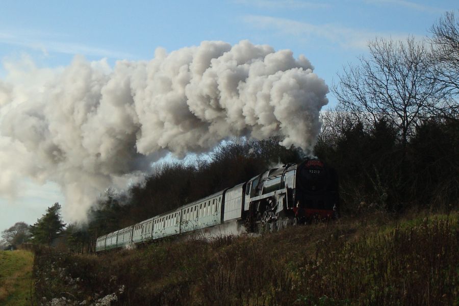 B.R. Standard class '9F' No. 92212 climbs away from Ropley with a 'Santa Special' service from Alresford. (18th December 2011)