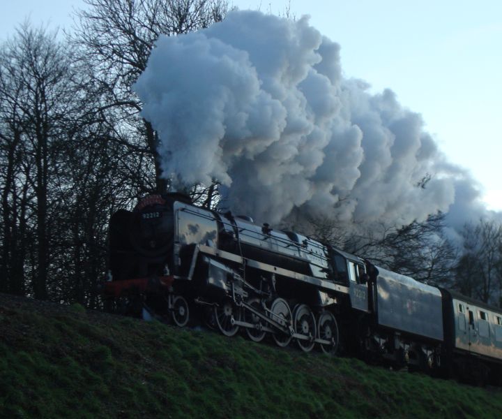 B.R. Standard class '9F' No. 92212 seen at sunset between Ropley and Medstead & Four Marks with a 'Santa Special' service from Alresford. (18th December 2011)